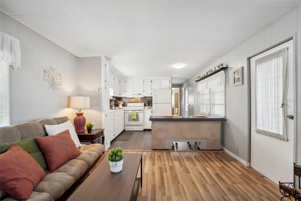 1600 Old Coachman Rd., Unit 709 Clearwater, FL 33765 - Photo 6 of 23 a living room with stainless steel appliances furniture and a kitchen view