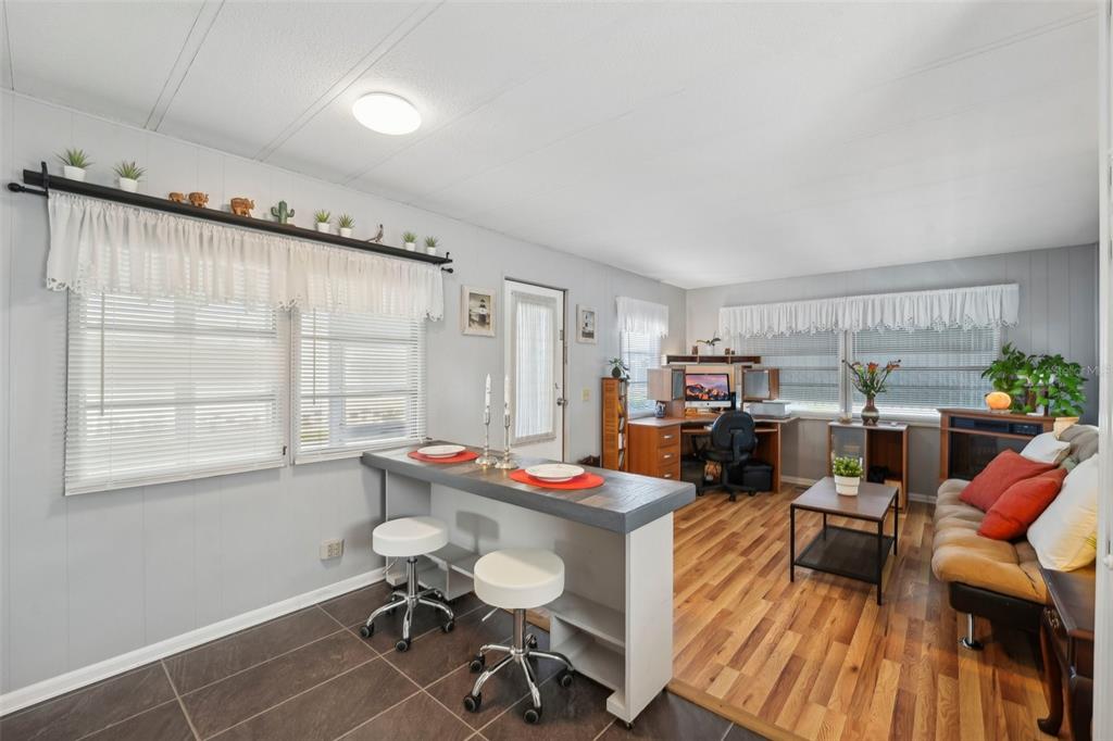1600 Old Coachman Rd., Unit 709 Clearwater, FL 33765 - Photo 7 of 23 a living room with furniture a window and gym equipment