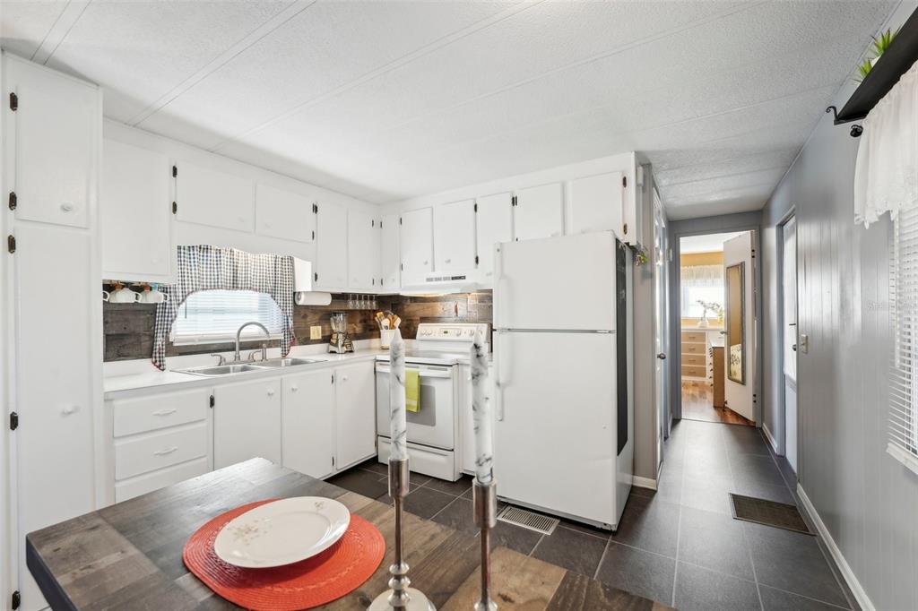 1600 Old Coachman Rd., Unit 709 Clearwater, FL 33765 - Photo 8 of 23 a kitchen with white cabinets and white appliances