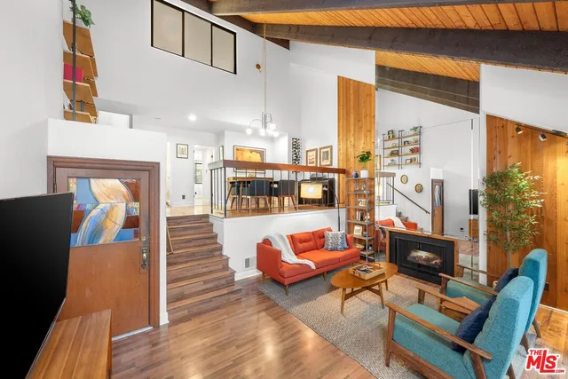 a living room with furniture and a floor to ceiling window