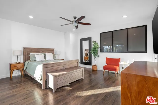 a spacious bedroom with a bed and a couch