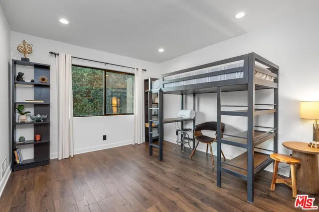a view of room with furniture and wooden floor