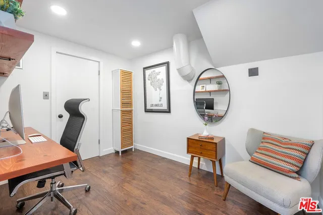 a view of a patio with a table and chairs under an umbrella