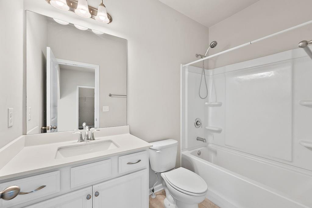 2415 Matlin Way Buford, GA 30519 - Photo 35 of 65 a bathroom with a sink a toilet and shower