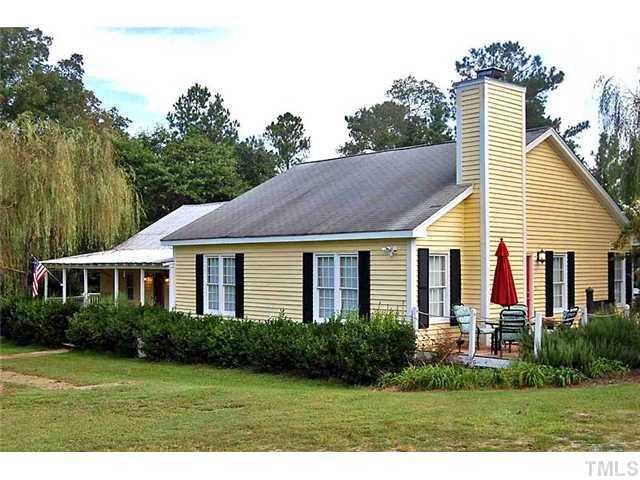230 W Road Angier, NC 27501 - Photo 1 of 14 a view of a house with a yard and potted plants