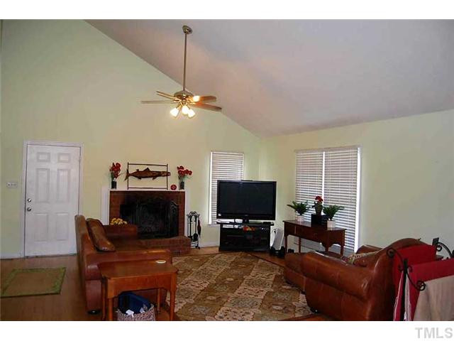 230 W Road Angier, NC 27501 - Photo 3 of 14 a living room with furniture a fireplace and a flat screen tv