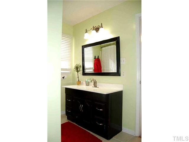 230 W Road Angier, NC 27501 - Photo 6 of 14 a bathroom with a sink and a mirror