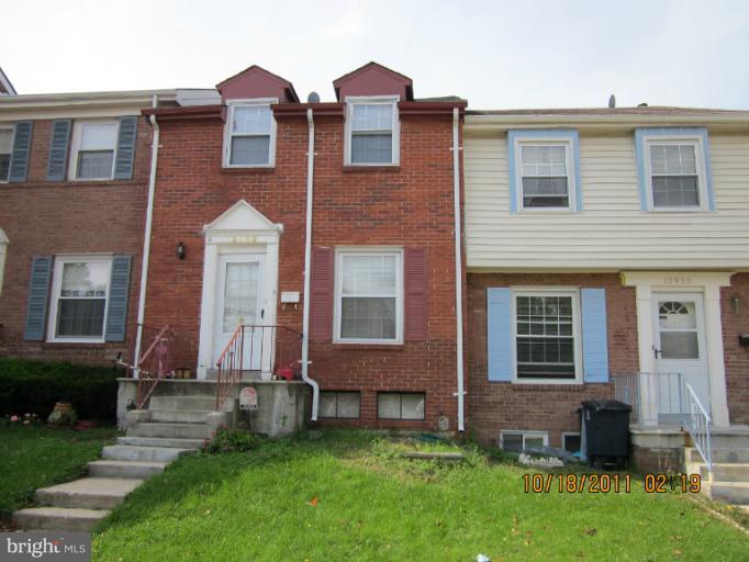 12928 Claxton Drive, Unit 6E Laurel, MD 20708 - Photo 1 of 18 front view of a house with a yard