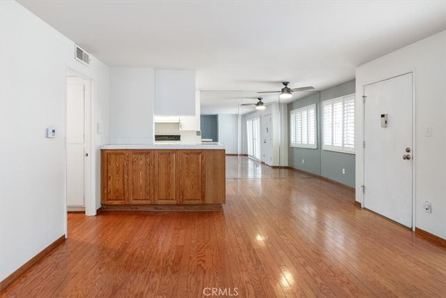 a view of a room with wooden floor and window