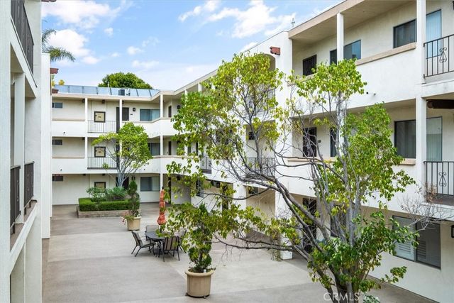 a front view of a multi story building with a yard