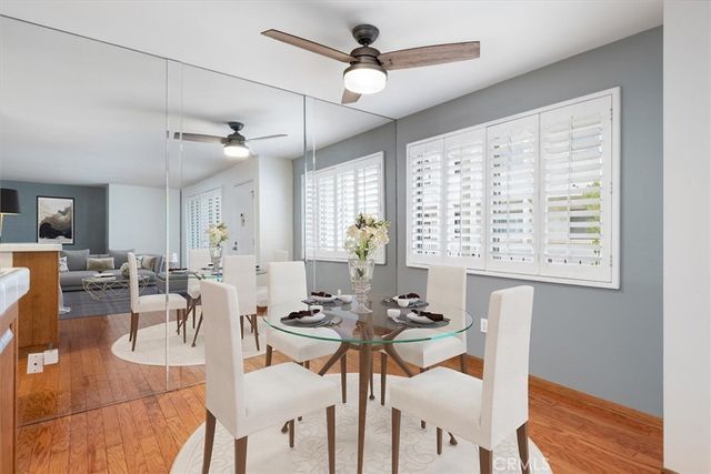 a view of a dining room with furniture window and wooden floor