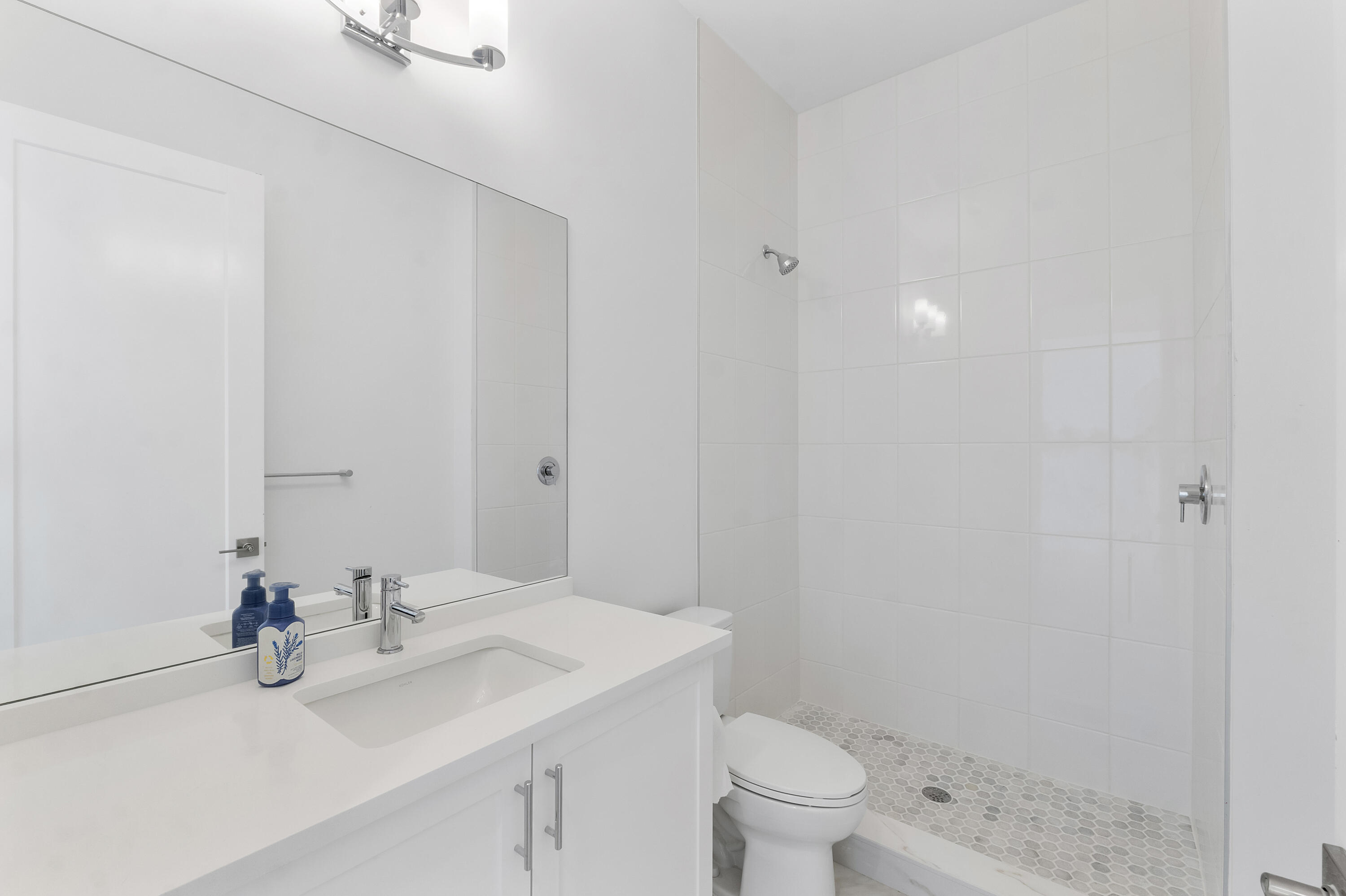 9322 Sunflower Mdw Road Boca Raton, FL 33434 - Photo 20 of 87 a bathroom with a sink toilet and shower