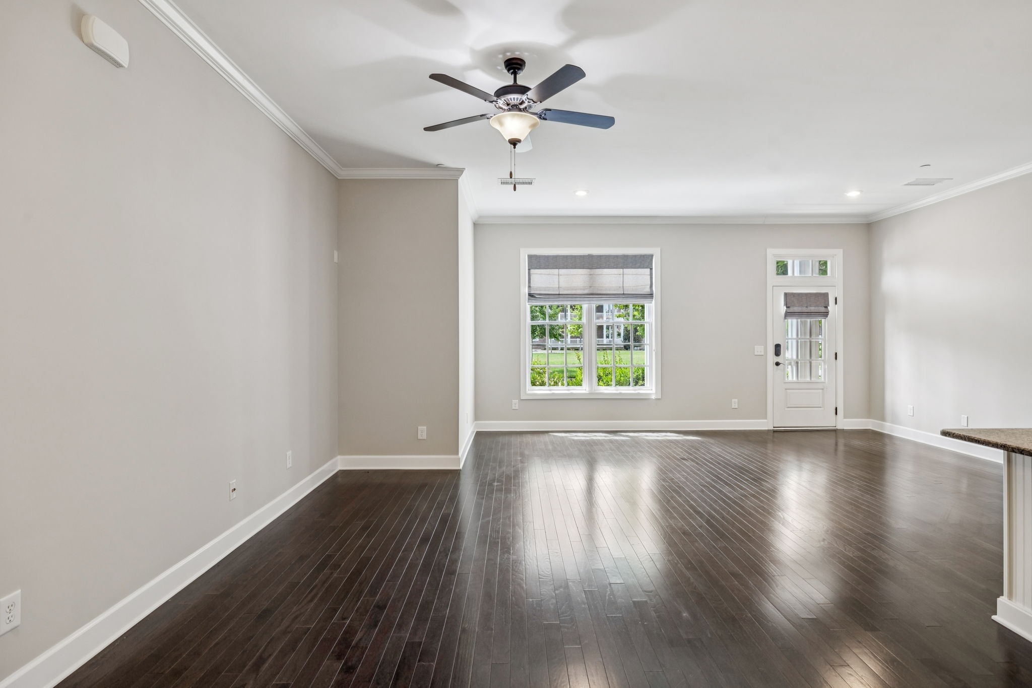 201 Swain Circle, Unit 104 Franklin, TN 37064 - Photo 11 of 45 an empty room with wooden floor chandelier fan and windows