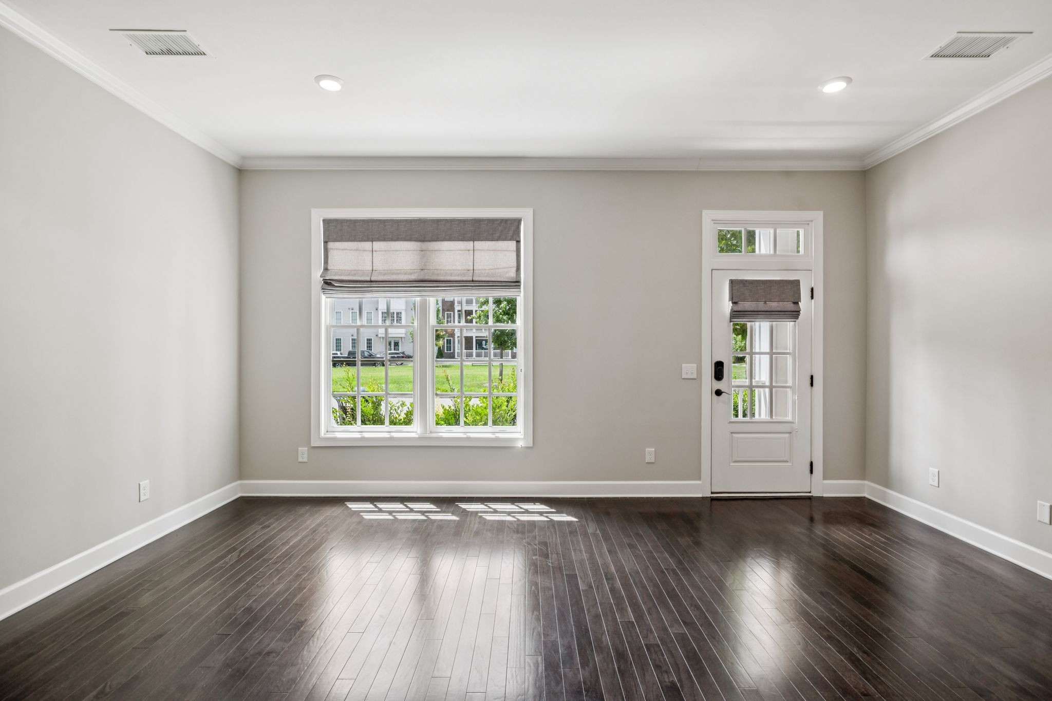 201 Swain Circle, Unit 104 Franklin, TN 37064 - Photo 14 of 45 an empty room with wooden floor and windows