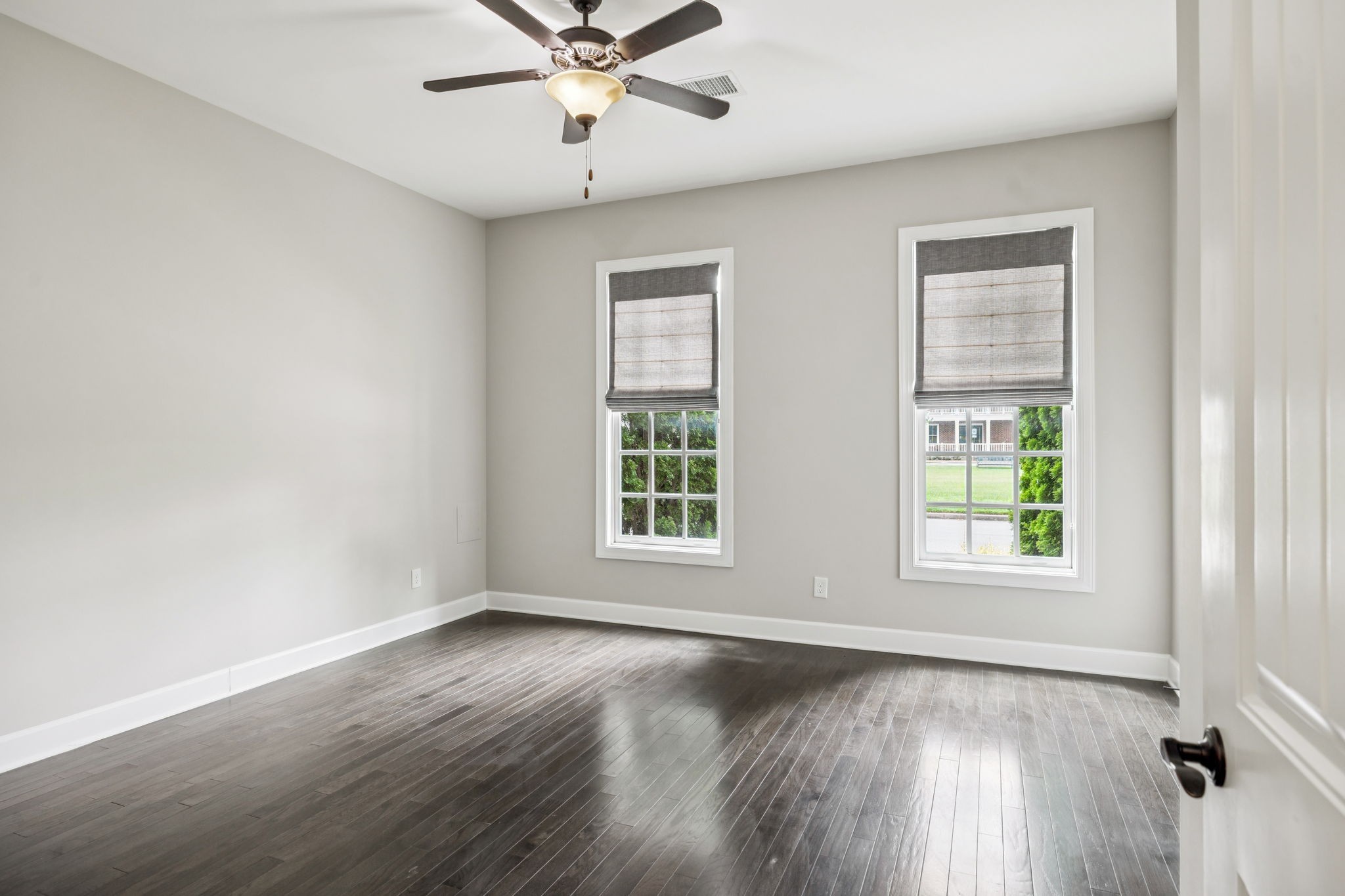 201 Swain Circle, Unit 104 Franklin, TN 37064 - Photo 18 of 45 a view of an empty room with wooden floor and a window