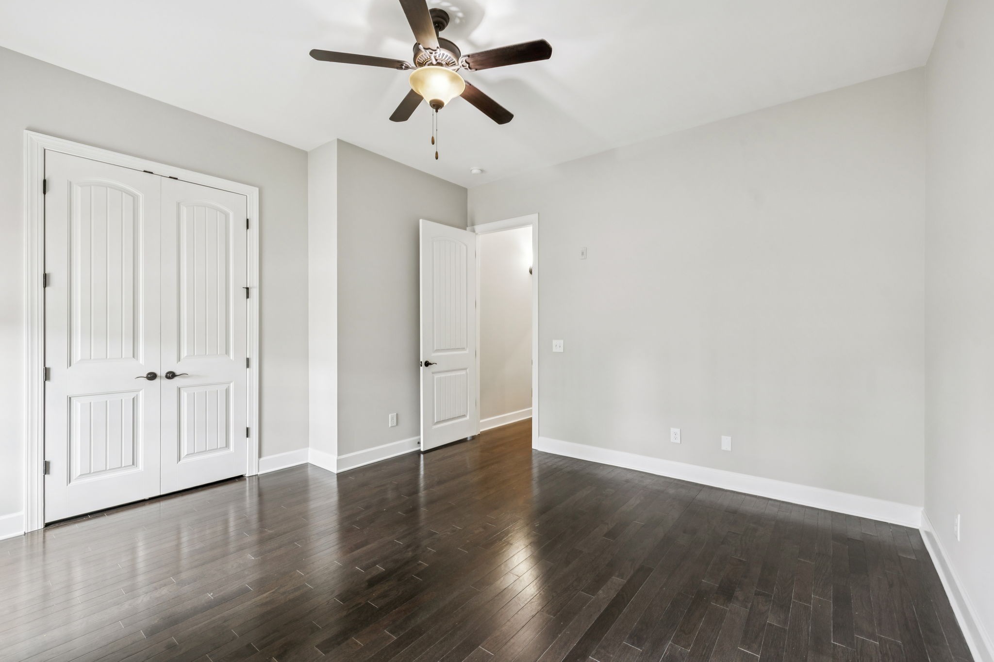 201 Swain Circle, Unit 104 Franklin, TN 37064 - Photo 19 of 45 an empty room with wooden floor ceiling fan and windows