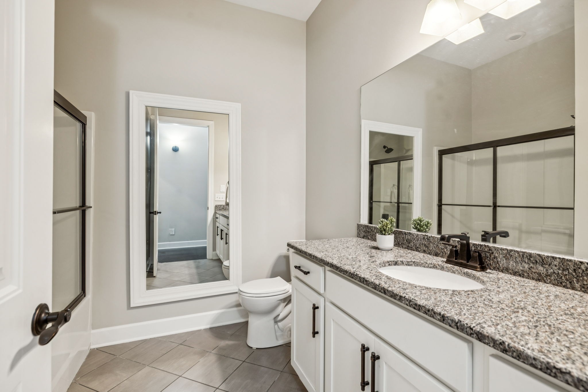 201 Swain Circle, Unit 104 Franklin, TN 37064 - Photo 20 of 45 a bathroom with a granite countertop sink toilet and shower