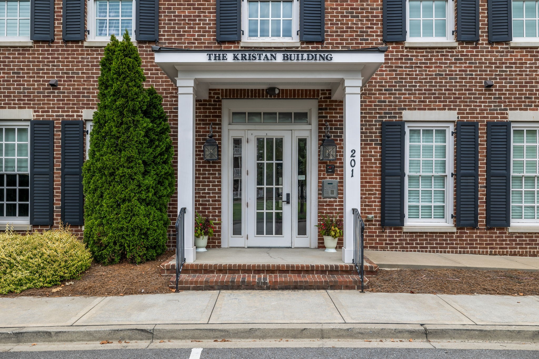 201 Swain Circle, Unit 104 Franklin, TN 37064 - Photo 2 of 45 a view of a brick house with plants