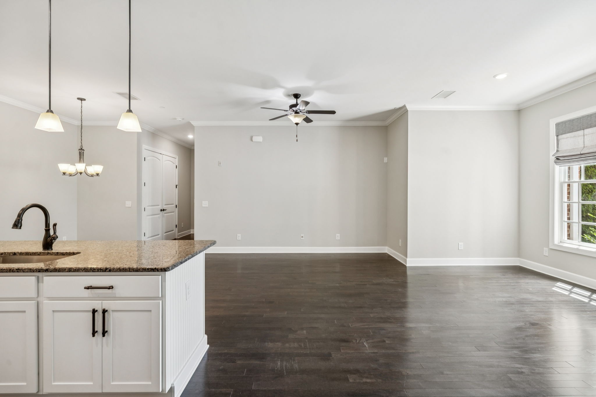 201 Swain Circle, Unit 104 Franklin, TN 37064 - Photo 21 of 45 a view of a kitchen with a sink dishwasher and a fireplace with wooden floor