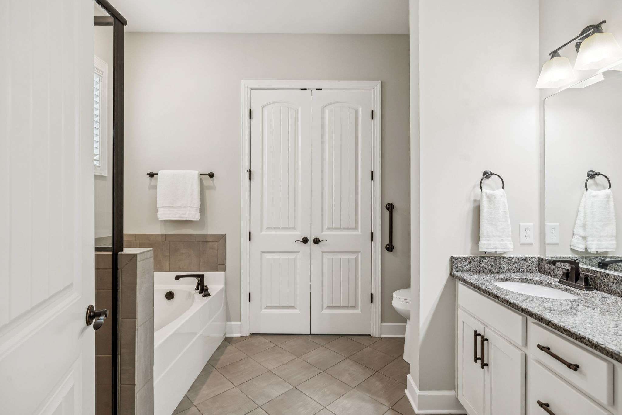 201 Swain Circle, Unit 104 Franklin, TN 37064 - Photo 31 of 45 a bathroom with a granite countertop sink and a mirror