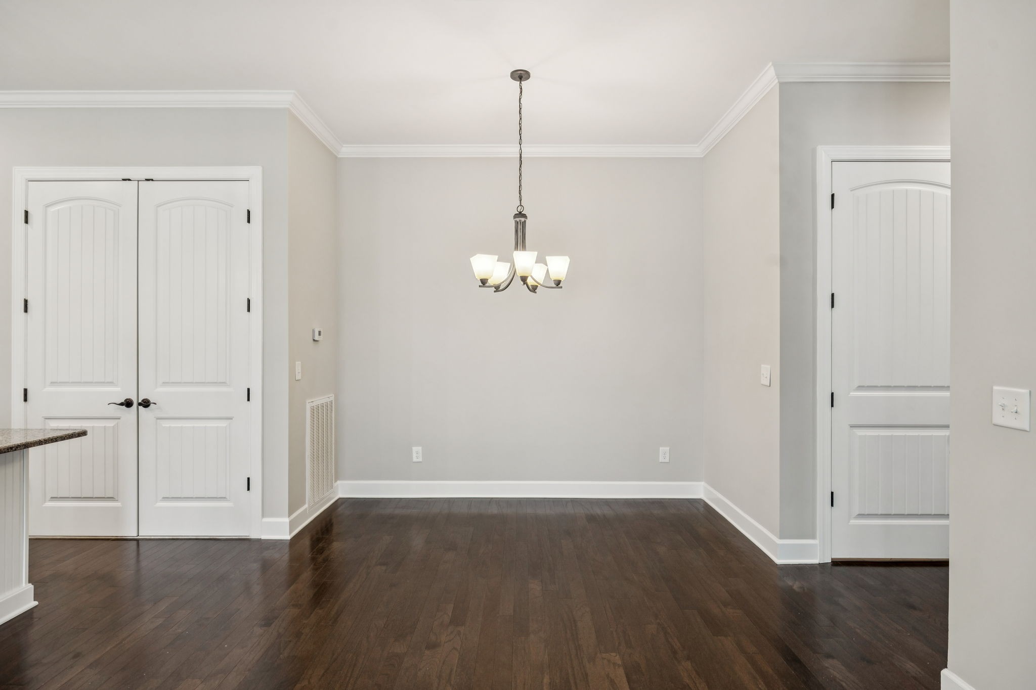 201 Swain Circle, Unit 104 Franklin, TN 37064 - Photo 7 of 45 a view of a room with wooden floor and ceiling fan