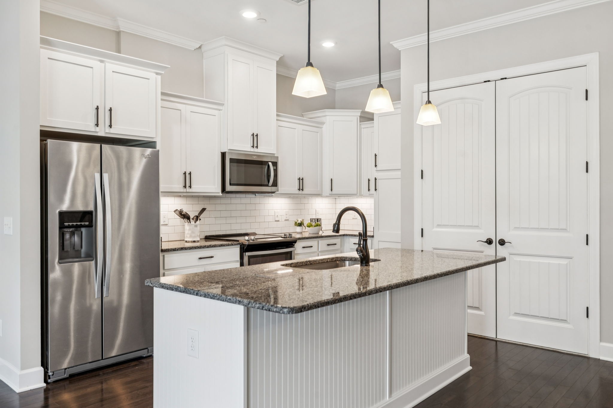 201 Swain Circle, Unit 104 Franklin, TN 37064 - Photo 9 of 45 a kitchen with stainless steel appliances granite countertop a refrigerator a sink and white cabinets