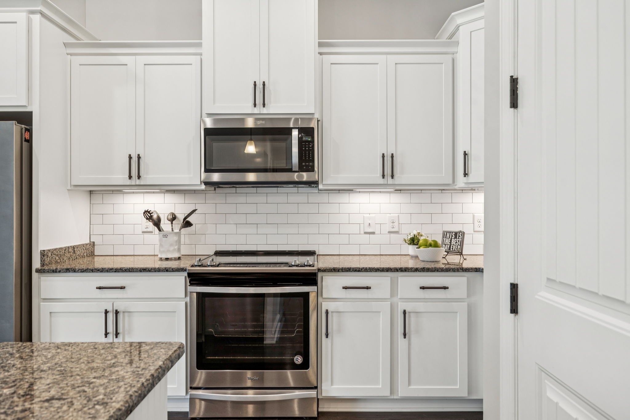 201 Swain Circle, Unit 104 Franklin, TN 37064 - Photo 10 of 45 a kitchen with granite countertop white cabinets and stainless steel appliances
