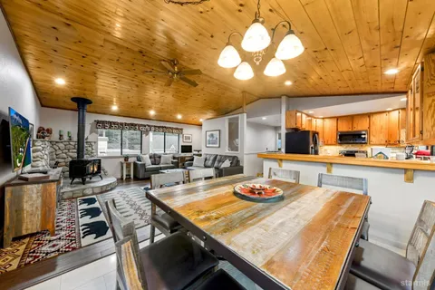 a outdoor kitchen with a table and chairs in it