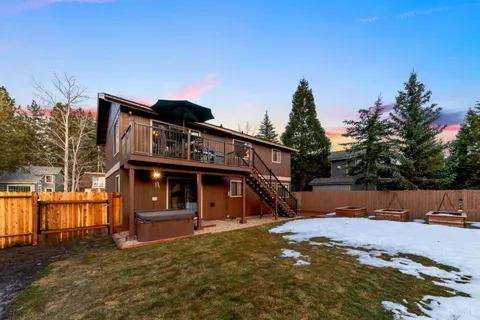a view of a house with wooden fence