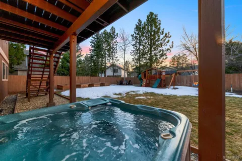 a view of a backyard with plants and a patio