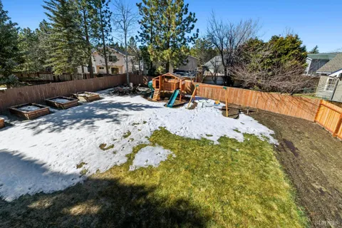 a view of a backyard with wooden fence