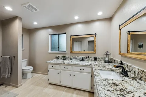 a bathroom with a double vanity sink and a mirror