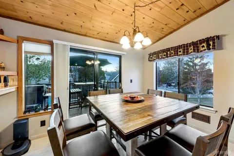 a view of a dining room with furniture wooden floor and chandelier