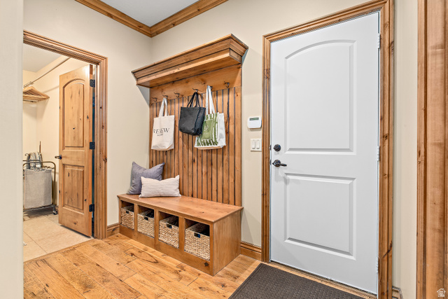 552 East Johns Way Sandy, UT 84070 - Photo 34 of 67 Wood-finish flooring with a built-in bench and coat rack featuring hooks and cubby storage