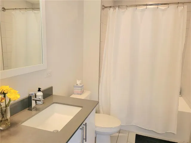 a bathroom with a toilet a sink and a mirror