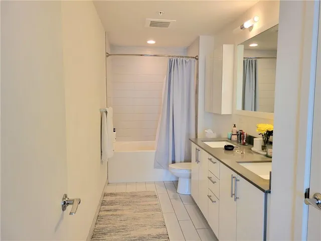 a bathroom with a sink a toilet and a mirror