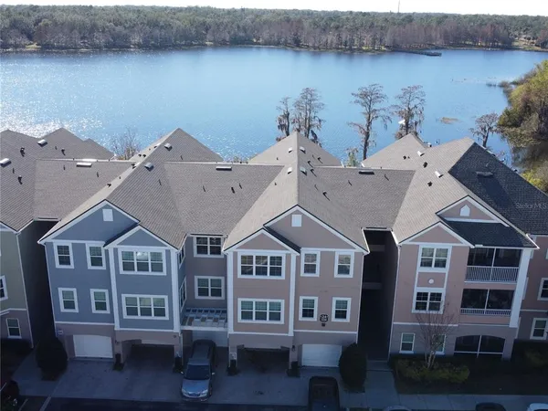 a view of a big house with a plants and more windows