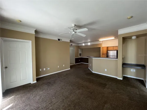 a view of a kitchen with a sink and a refrigerator