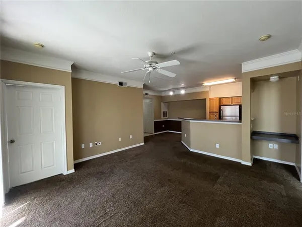 a view of a kitchen with a sink and a refrigerator