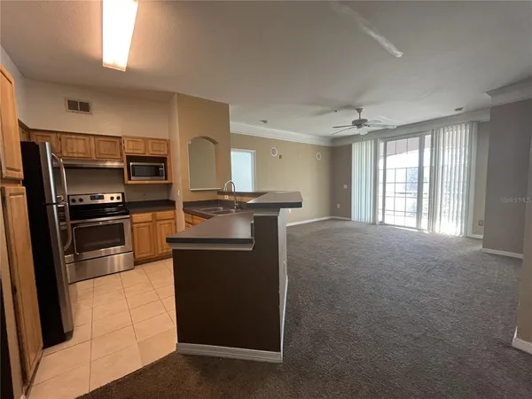 a kitchen with cabinets and stainless steel appliances