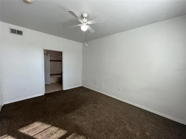 an empty room with a window and closet