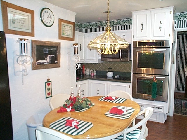 1541 Duke Road Waynesboro, VA 22980 - Photo 26 of 50 a kitchen with stainless steel appliances kitchen island granite countertop a refrigerator a stove a microwave oven a dining table and chairs with wooden floor