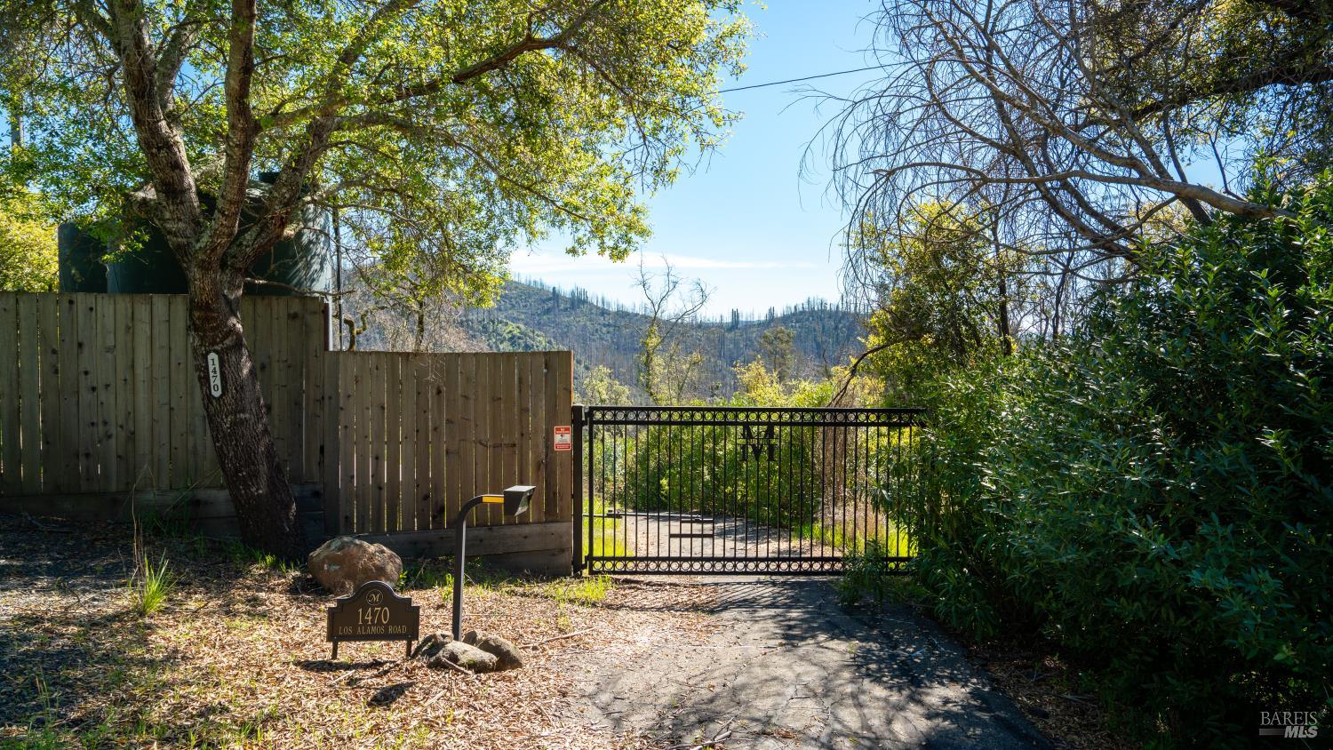 1470 Los Alamos Road Santa Rosa, CA 95409 - Photo 2 of 20 a backyard of a house with potted plants and large trees