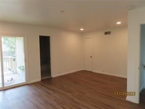 403 High Ridge Street Houston, TX 77013 - Photo 9 of 13 a view of an empty room with wooden floor and a window