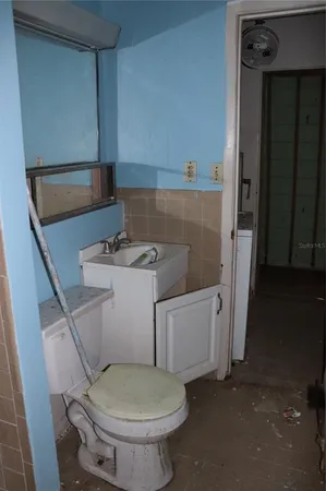 a bathroom with a toilet and a sink