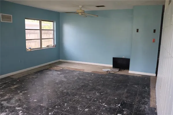 a view of room with ceiling fan and window