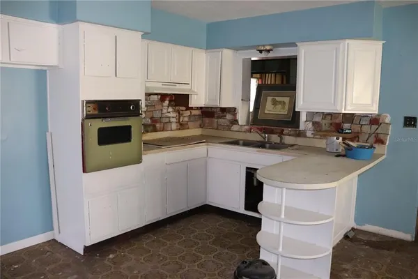 a kitchen with a sink stove and cabinets