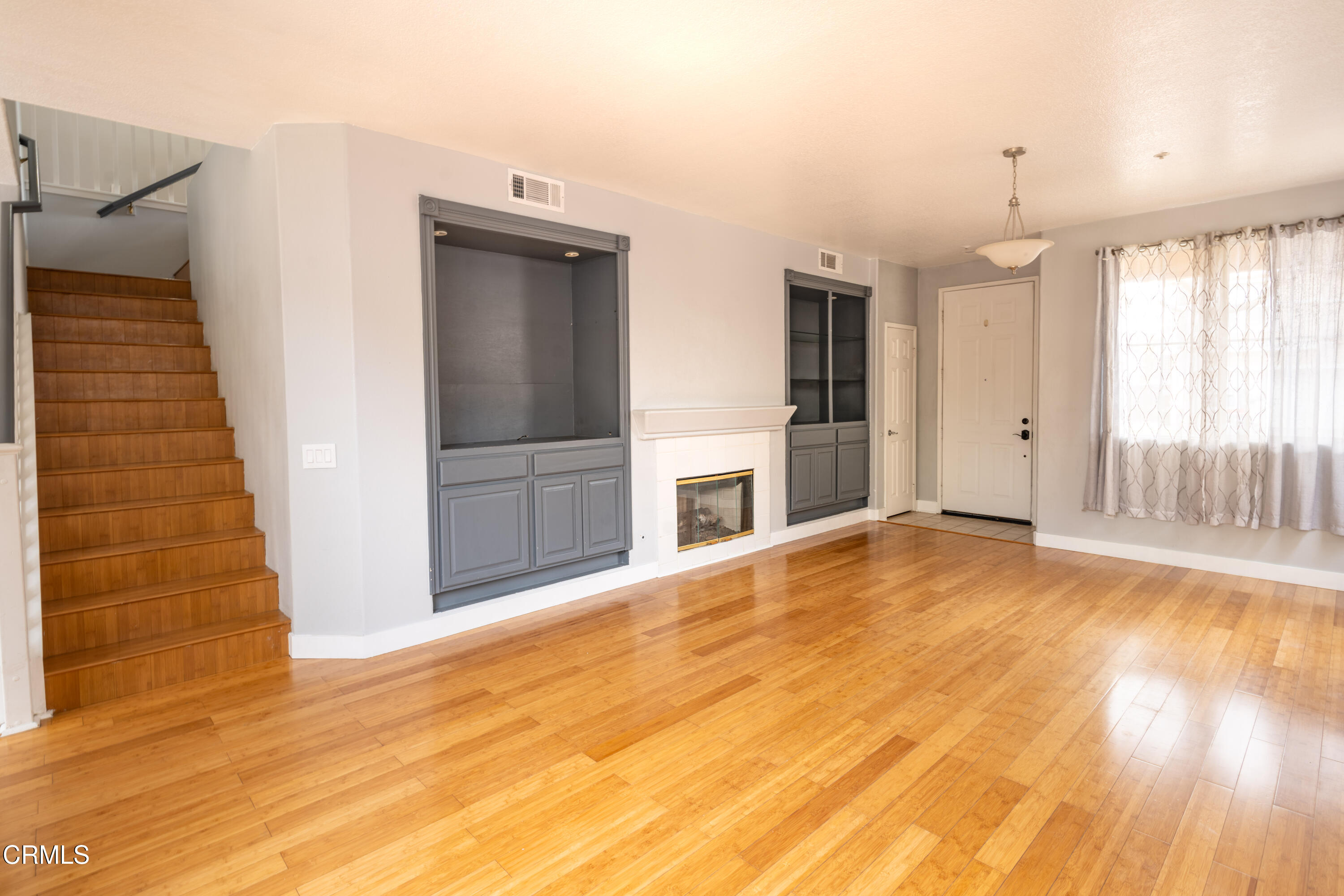 732 Pontoon Way Oxnard, CA 93035 - Photo 3 of 15 an empty room with wooden floor and windows