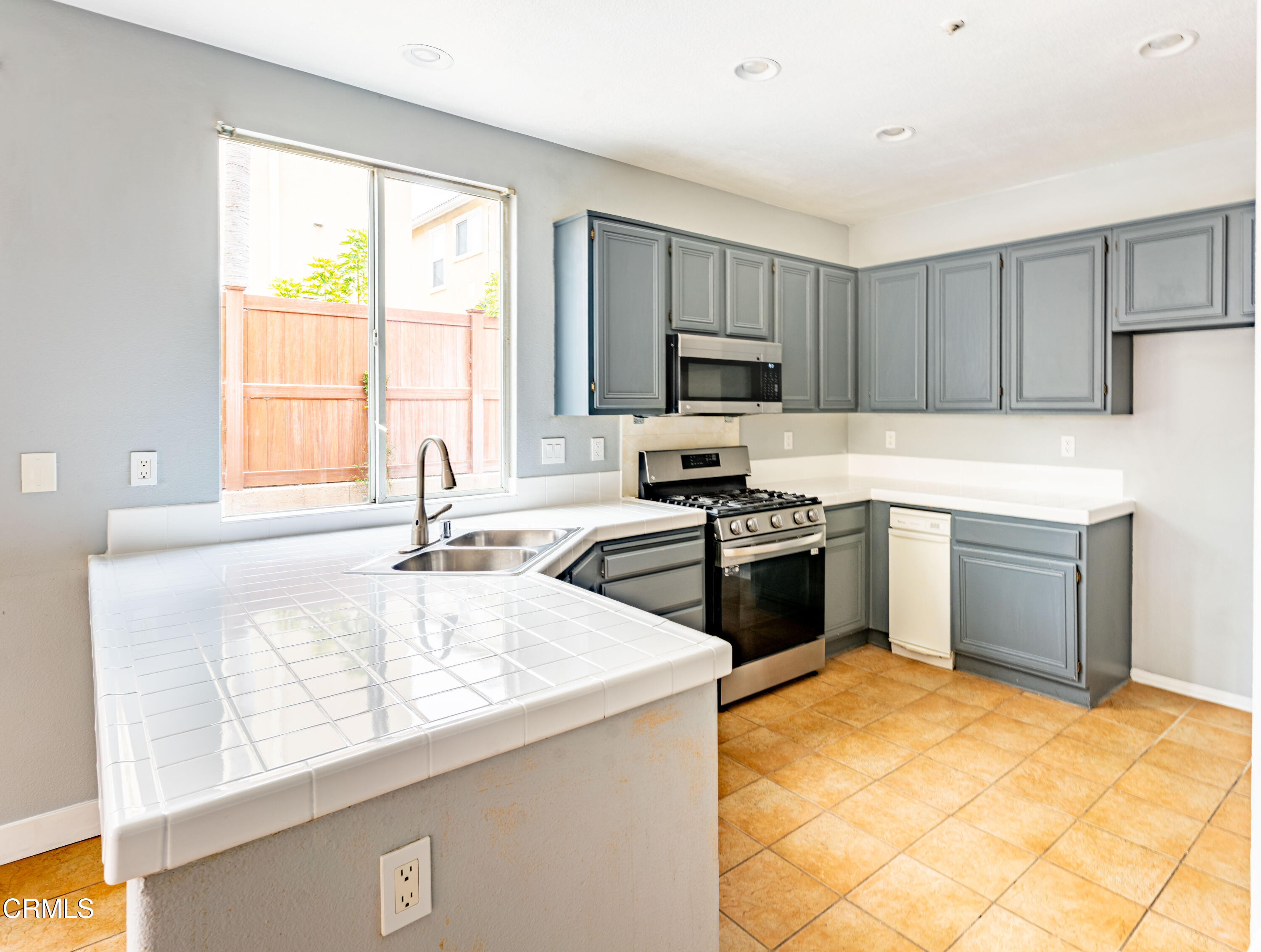 732 Pontoon Way Oxnard, CA 93035 - Photo 6 of 15 a kitchen with a stove a sink and a microwave