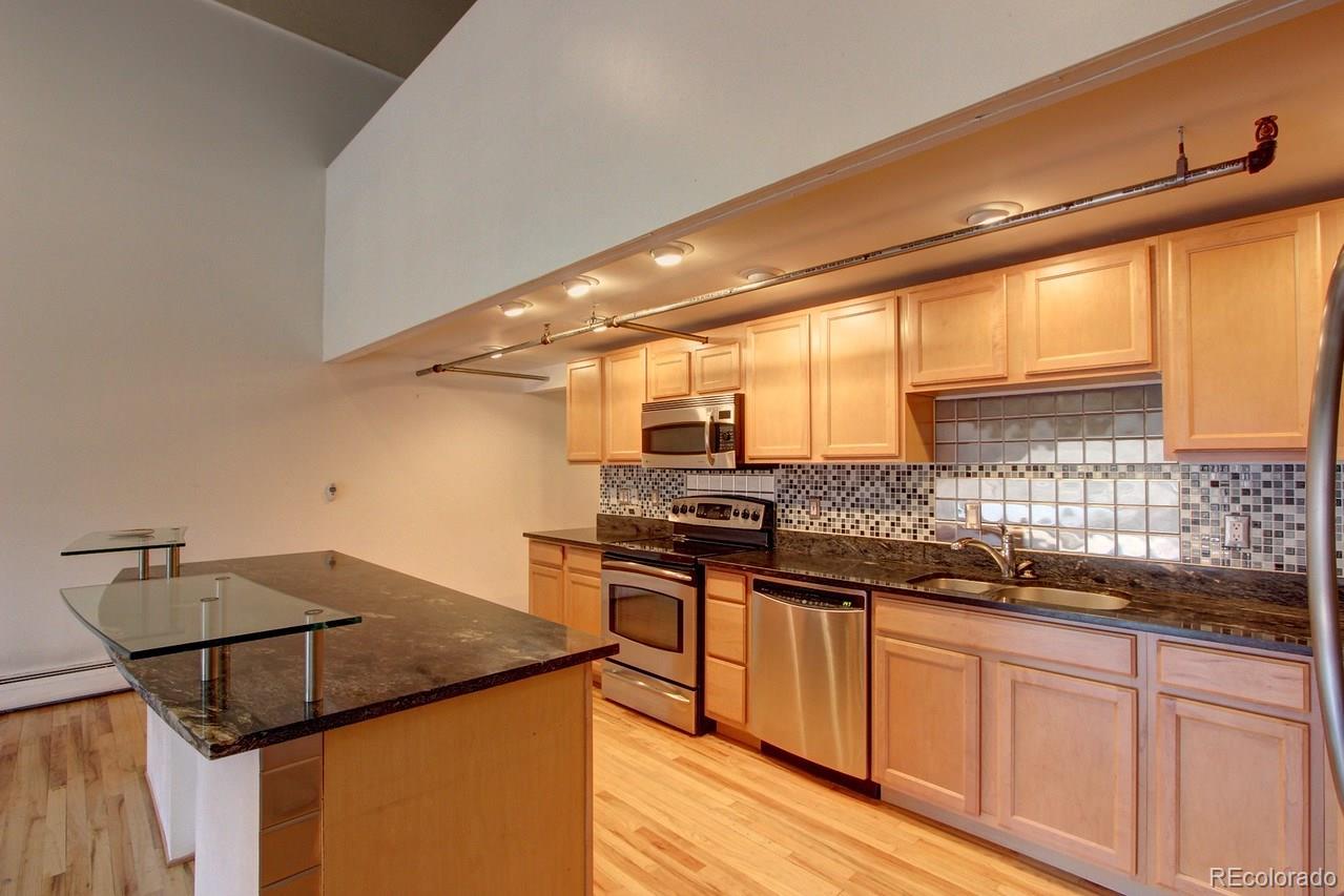 3377 Blake Street, Unit 202 Denver, CO 80205 - Photo 16 of 19 a kitchen with a sink and cabinets
